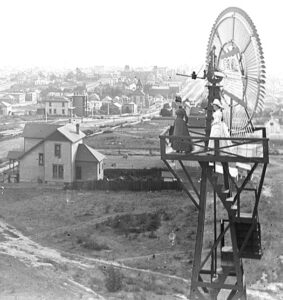 vintage photo of women standing on the platform of the original windmill, the city of…
